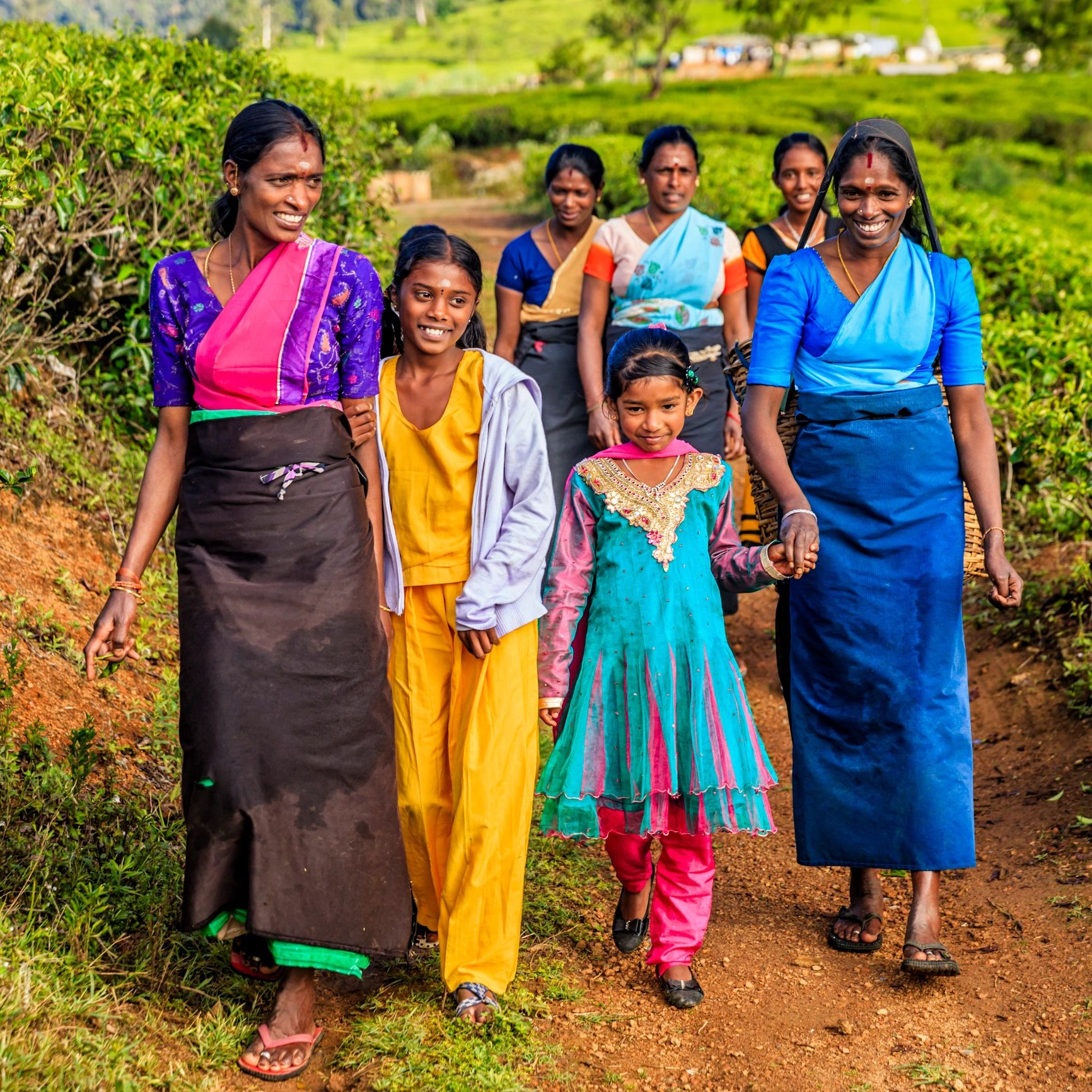 South Asian women and children in a rural field setting